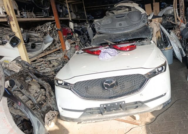 White Mazda CX-5 SUV front halfcut — grille, headlights, hood and bumper, Sharjah market