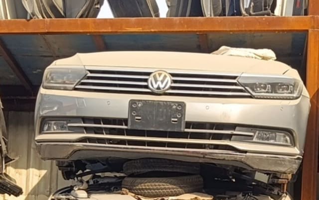 Silver Volkswagen Passat sedan front cut — bumper, VW grille and headlights, Sharjah market