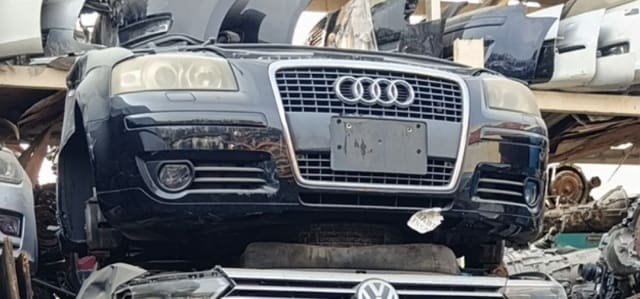 Black Audi A6 front cut — bumper, single-frame grille and projector headlights, Sharjah market