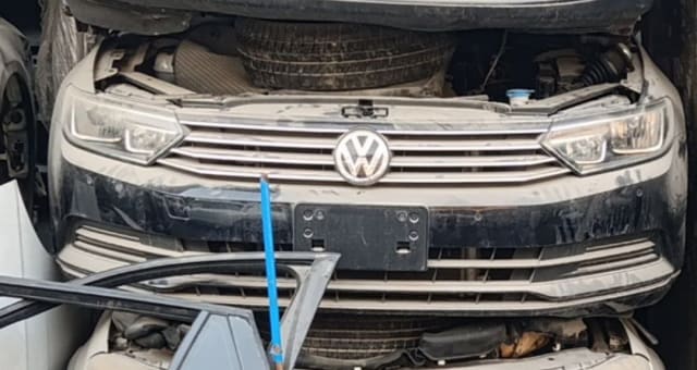 Beige Volkswagen Passat sedan front halfcut — bumper, grille, VW badge and headlights, Sharjah market