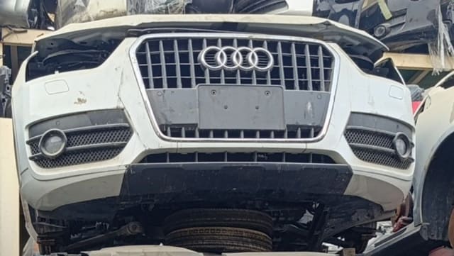 White Audi Q3 SUV front halfcut — front bumper, single-frame grille and fog lamps, Sharjah market