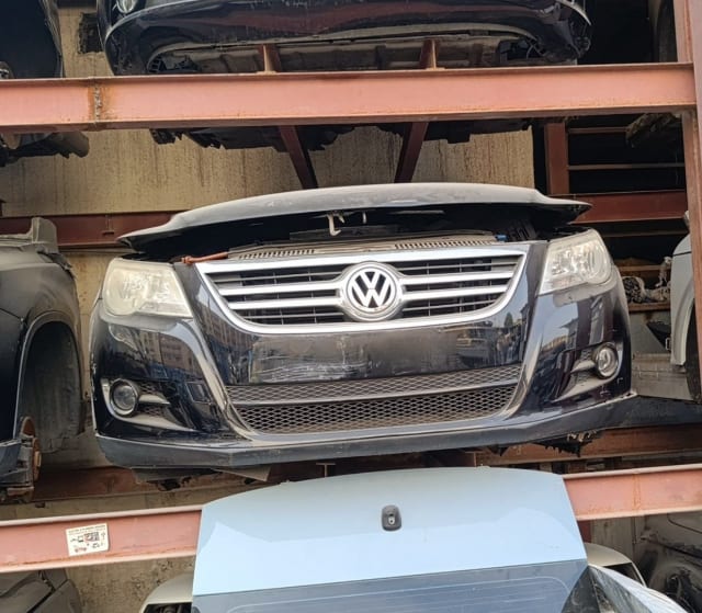 Black Volkswagen Tiguan front halfcut — bumper, chrome grille, headlights and hood, Sharjah market
