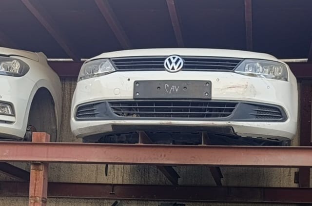 White Volkswagen Jetta sedan front cut — bumper, grille and headlights, Sharjah market