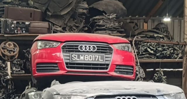 Red Audi A3 hatchback front cut — bumper, grille and headlights, Sharjah market