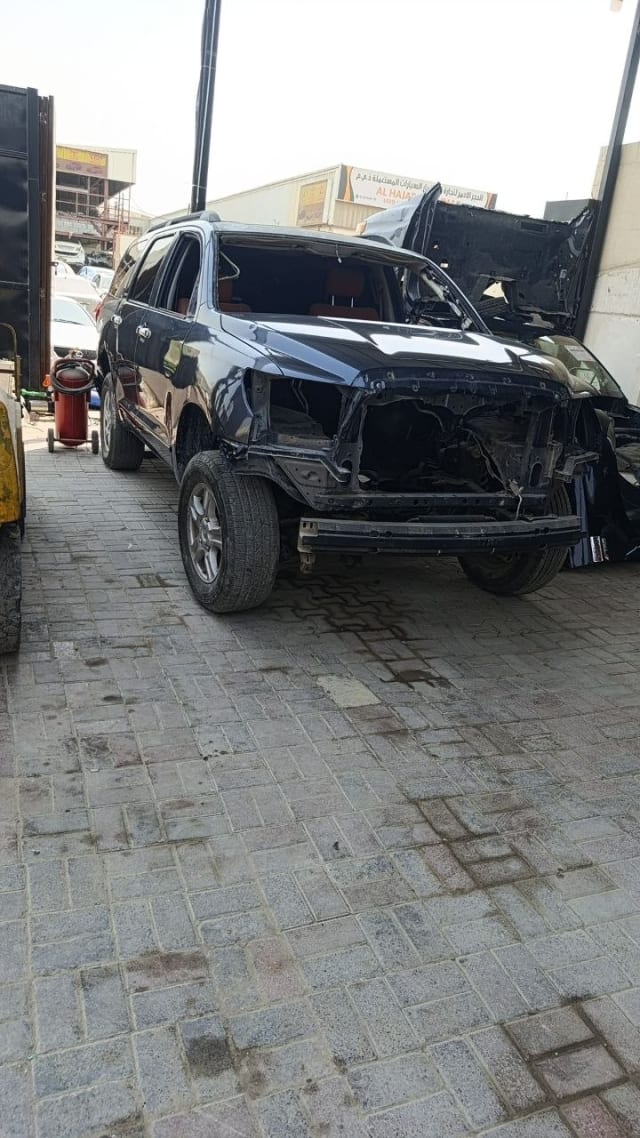 Dark grey Toyota Sequoia car for parts — front stripped, open hood and engine bay, doors and wheels, Sharjah market