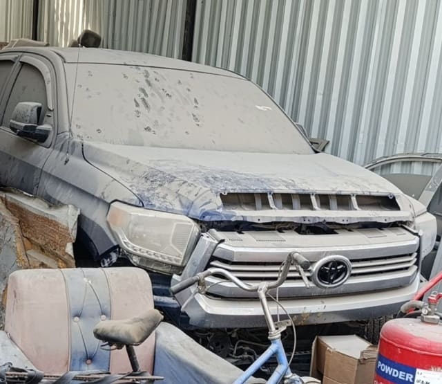 Dusty grey Toyota Tundra pickup front — bumper, grille, headlights and hood, Sharjah market