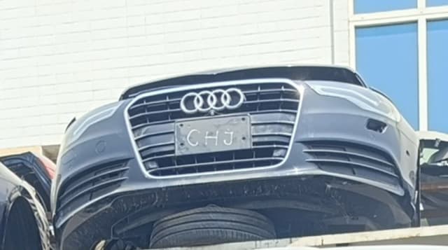 Dark grey Audi A6 sedan front cut — bumper, chrome grille and headlights, Sharjah market