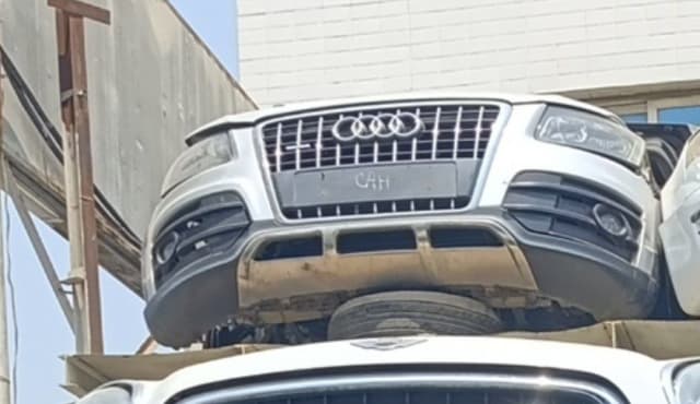White Audi Q5 SUV front cut — bumper, single-frame grille and headlights, Sharjah market