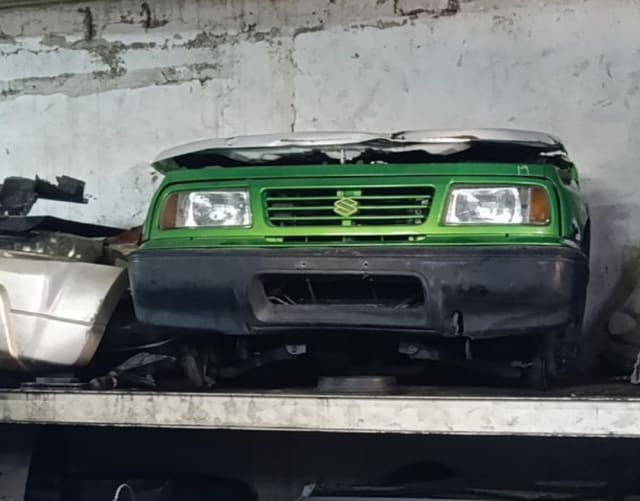 Green Suzuki Vitara SUV front halfcut — grille, headlights and bumper, Sharjah market