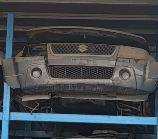 Silver-grey Suzuki Grand Vitara SUV front cut — bumper, grille and hood on rack, Sharjah market