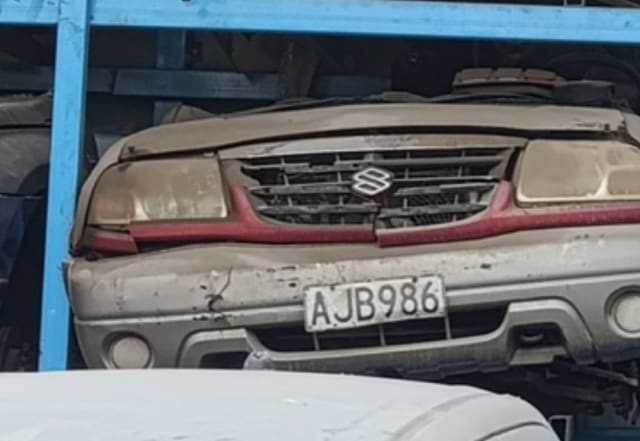 Beige Suzuki Grand Vitara SUV front halfcut — bumper, grille and headlights, Sharjah market