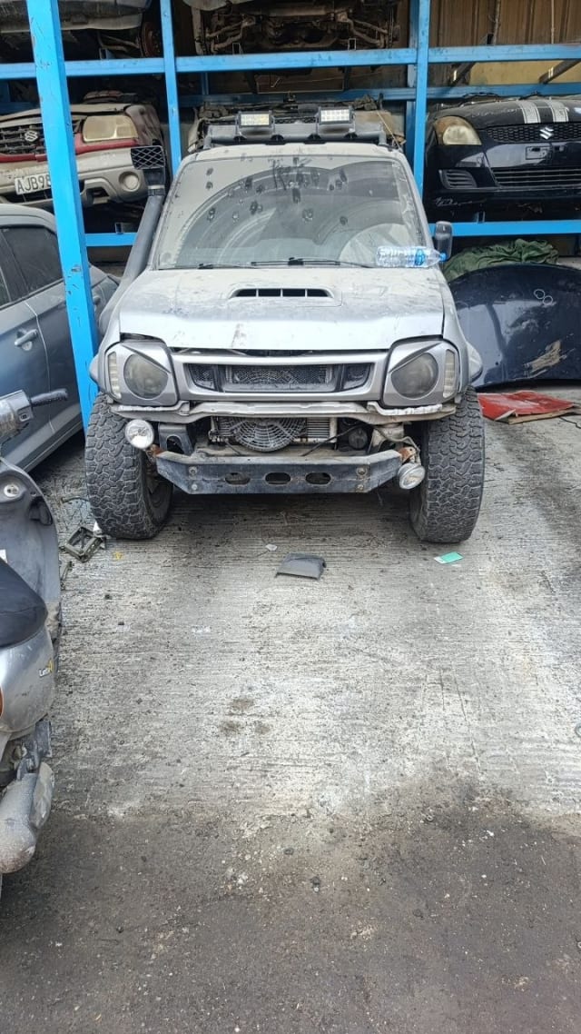 Silver Suzuki Jimny SUV front halfcut — hood, grille, headlights and front bumper, Sharjah market