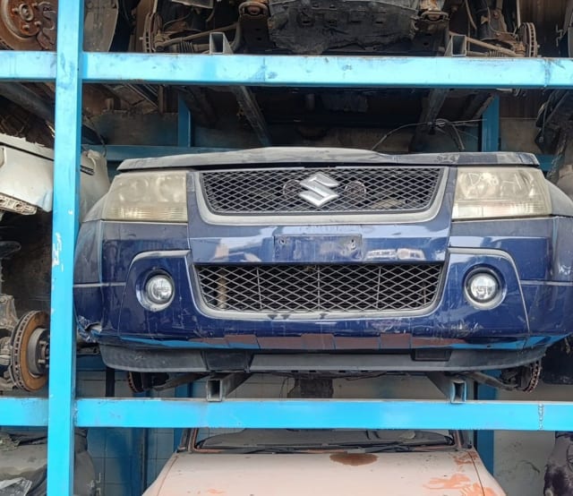 Blue Suzuki Grand Vitara SUV front cut — bumper, mesh grille, headlights and fog lamps, Sharjah market