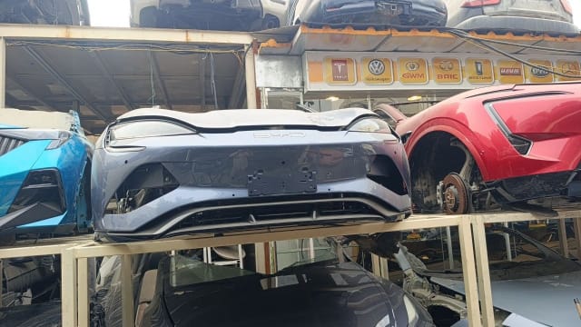 Grey-blue BYD front halfcut on a rack — front bumper, hood and grille, Sharjah market