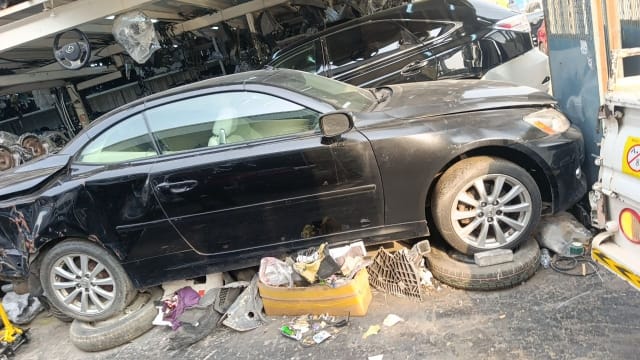 Black Toyota Camry Solara coupe side view for parts — doors, fender, alloy wheels and headlight, Sharjah market