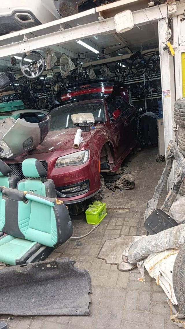 Burgundy Dodge Charger sedan halfcut — hood, headlights and doors with SRT seats, Sharjah market