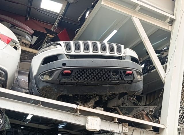 White Jeep Cherokee SUV front halfcut — grille, front bumper and fog lamps, Sharjah market