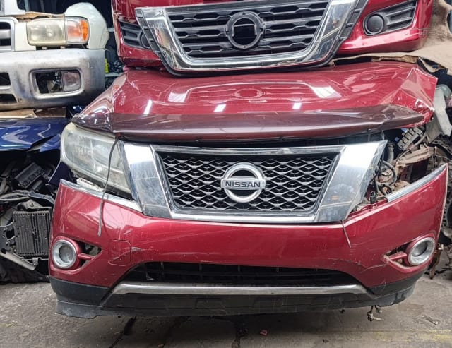 Dark red Nissan Pathfinder SUV front cut — bumper, chrome grille, headlights and hood, Sharjah market