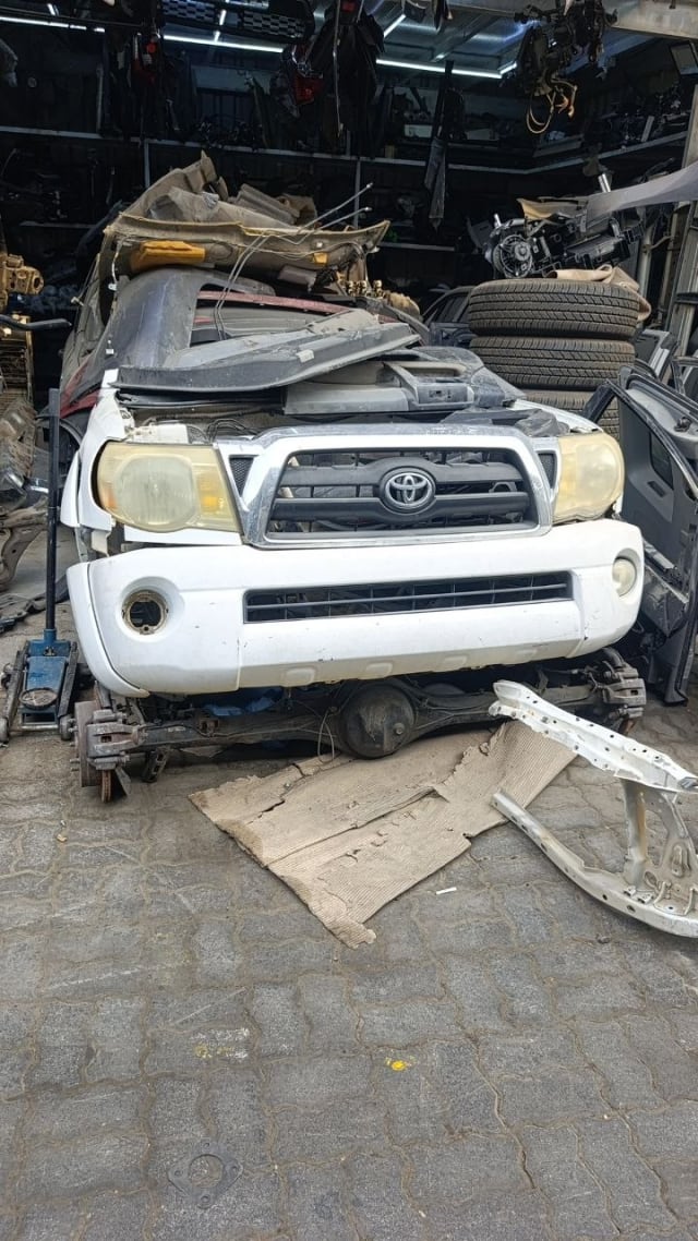 White Toyota Tacoma front halfcut — bumper, grille and headlights, Sharjah market