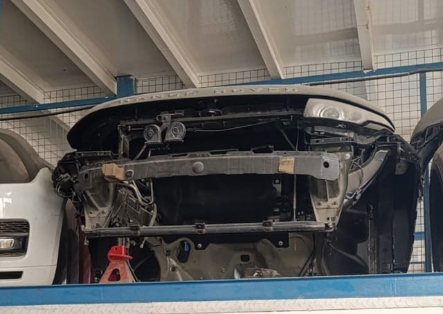 Dark grey Land Rover Range Rover SUV front halfcut — headlight, hood and radiator support, Sharjah market