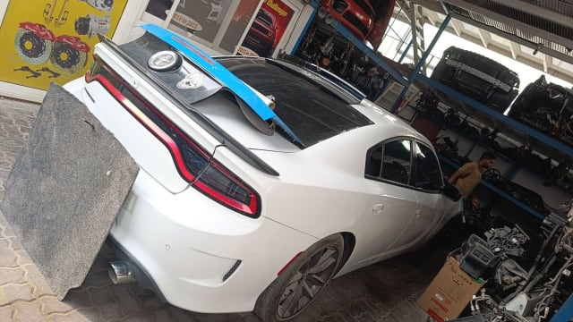 White Dodge Charger sedan rear — tail lights, spoiler, trunk lid and rear bumper, Sharjah market