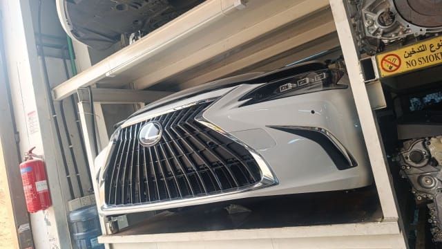 White Lexus ES sedan front cut — spindle grille, headlights and front bumper, Sharjah market