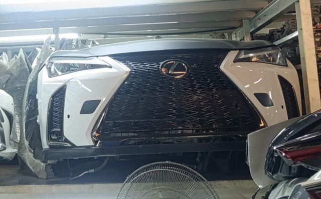 White Lexus UX SUV front cut — spindle grille, headlights and front bumper, Sharjah market
