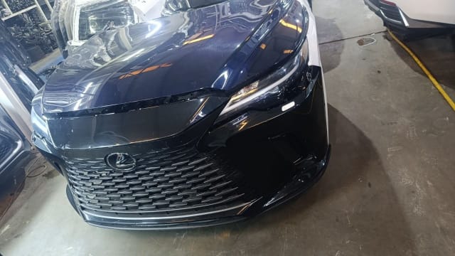 Black Lexus RX SUV front cut — hood, spindle grille, bumper and headlight, Sharjah market