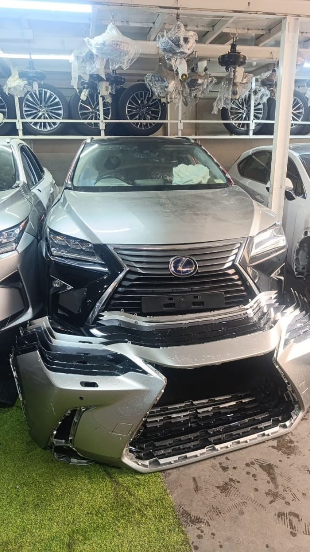 Silver Lexus RX SUV front halfcut — hood, fenders, spindle grille and headlights with separate front bumper, Sharjah market