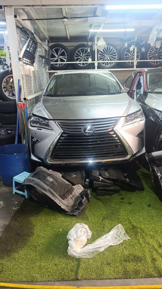 Silver Lexus RX SUV front halfcut — bumper, spindle grille, headlights and hood, Sharjah market