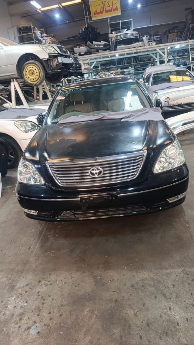 Black Toyota Celsior sedan front halfcut — bumper, chrome grille, headlights and hood, Sharjah market