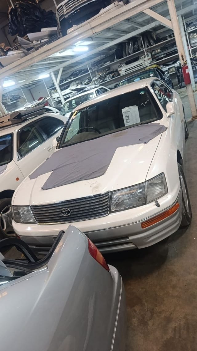 White Toyota Celsior sedan front — grille, headlights, bumper and hood, Sharjah market
