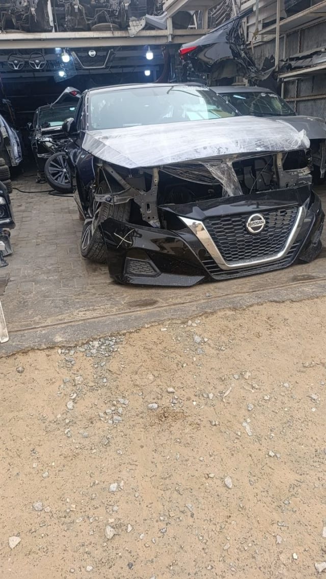 Black Nissan Altima sedan front cut — grille, front bumper and hood, Sharjah market