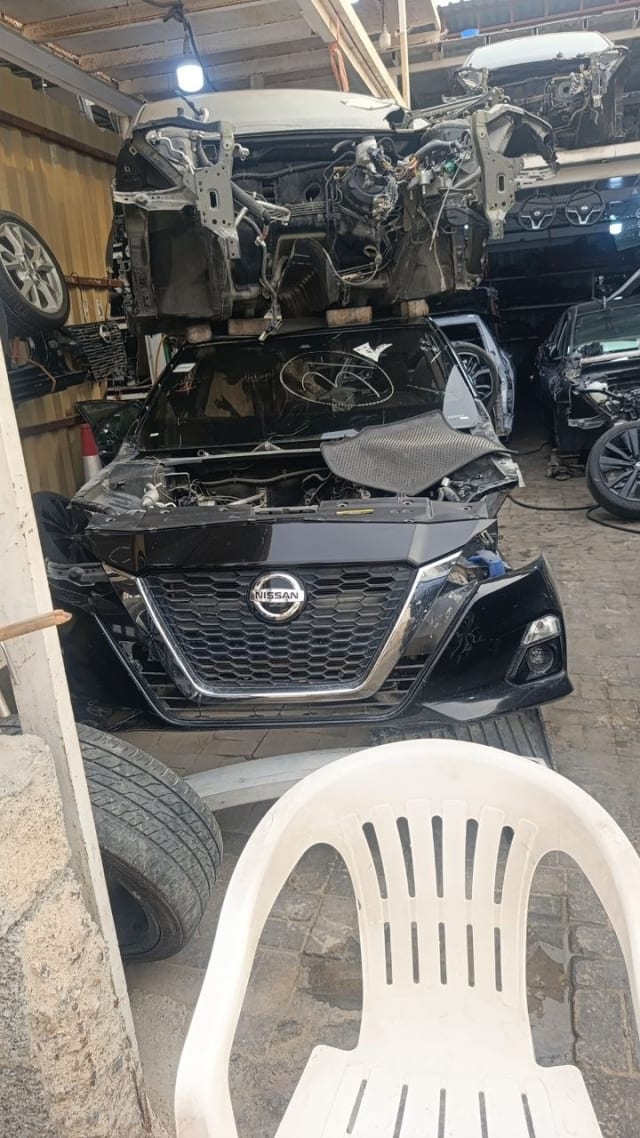 Black Nissan Altima sedan halfcut front cut — bumper, grille and fog lights, Sharjah market