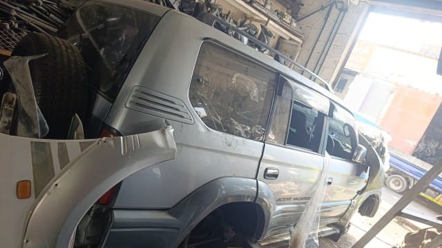 Silver Toyota Land Cruiser Prado SUV halfcut — rear doors, quarter panel and glass, Sharjah market