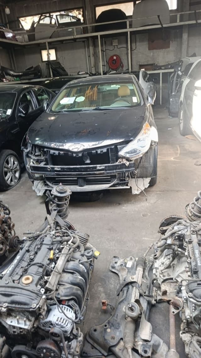 Black Hyundai Elantra sedan halfcut — front stripped, headlights, hood and radiator support, Sharjah market