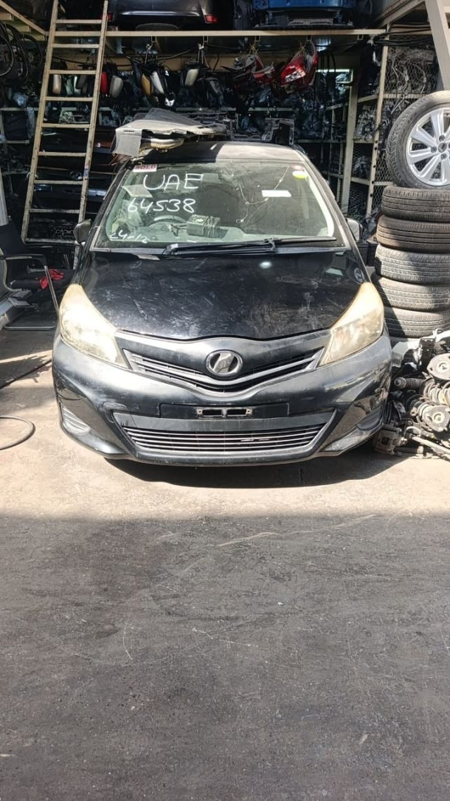 Black Toyota Yaris hatchback front halfcut — bumper, grille and headlights, Sharjah market