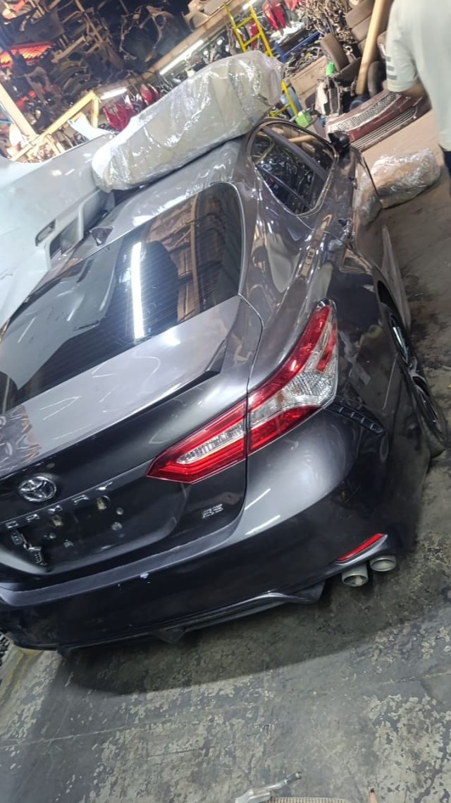 Dark grey Toyota Camry sedan rear halfcut — tail lights, trunk lid and rear bumper, Sharjah market