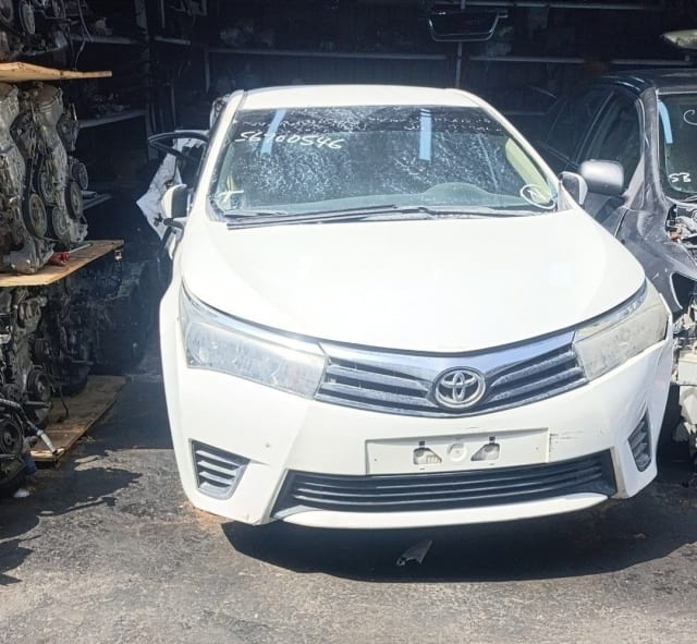 White Toyota Corolla sedan front cut — bumper, grille and headlights, Sharjah market