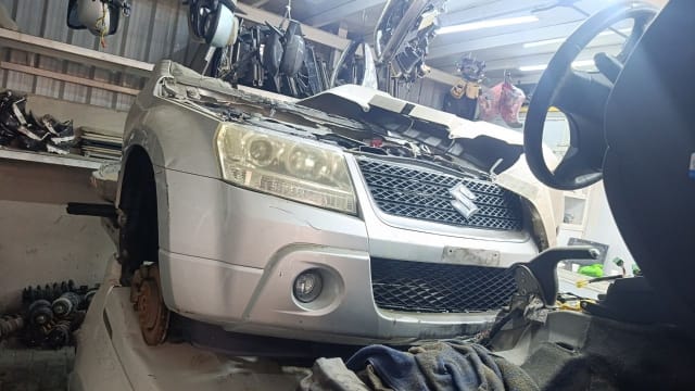 Silver Suzuki Grand Vitara front cut — bumper, chrome grille, headlight and fog light, Sharjah market