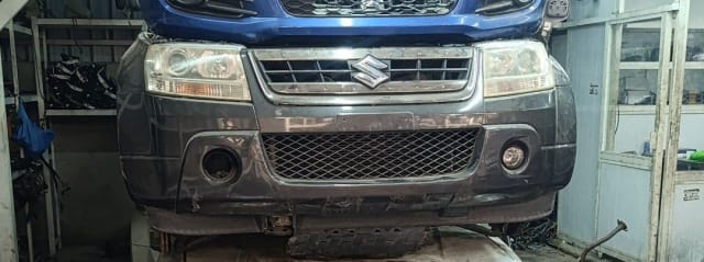 Blue Suzuki Grand Vitara SUV front cut — grille, headlights and grey bumper, Sharjah market