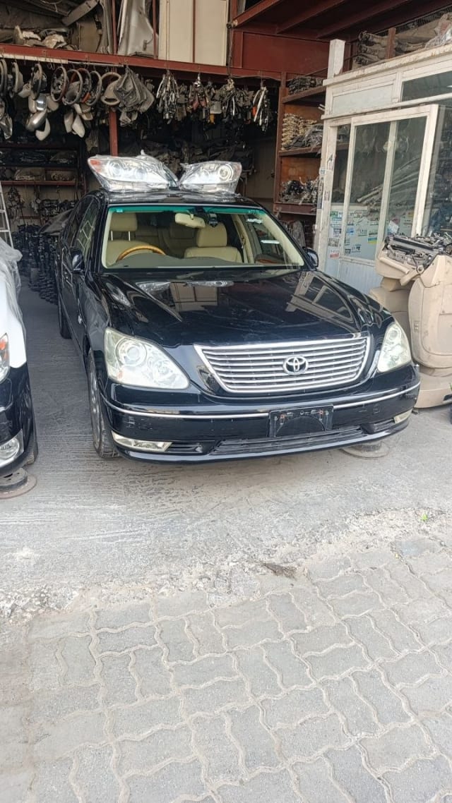 Black Toyota Celsior sedan front — grille, headlights, bumper and hood, Sharjah market