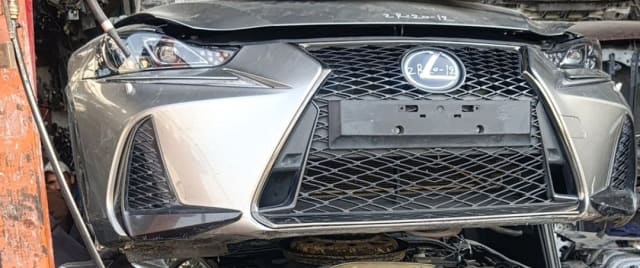Dark grey Lexus IS sedan front cut — spindle grille, bumper and headlights, Sharjah market