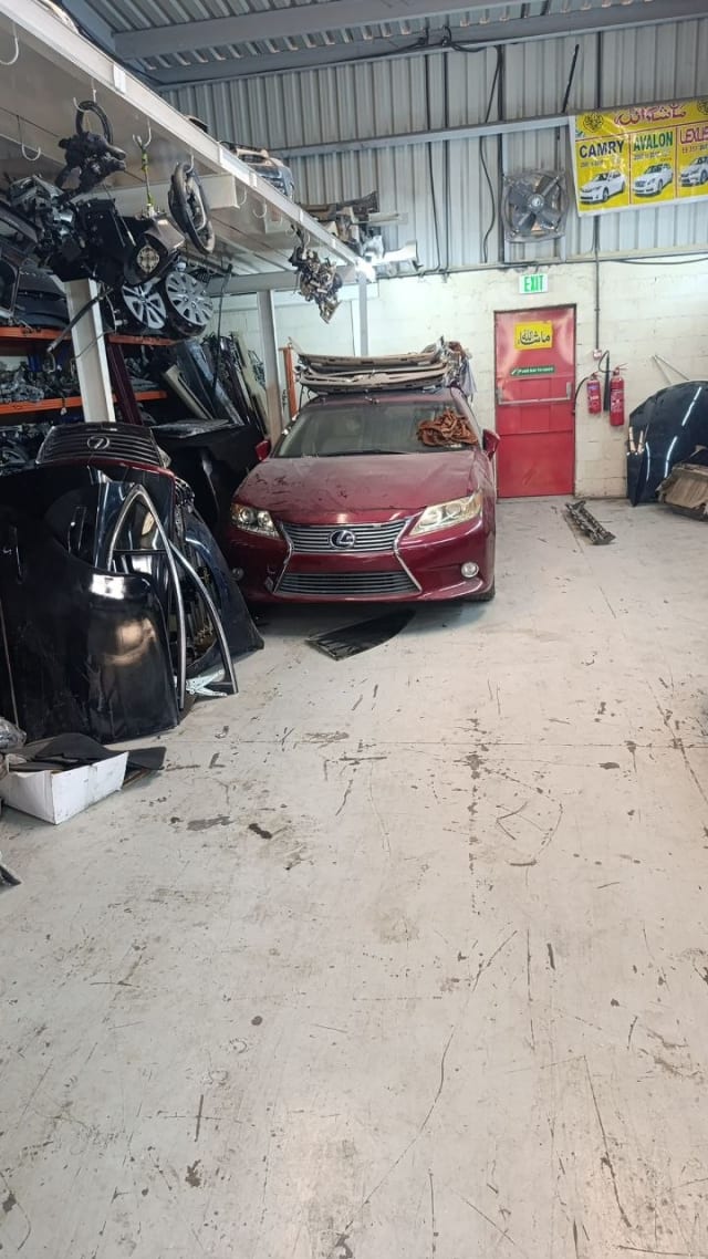 Dark red Lexus ES sedan front cut — bumper, grille and headlights, Sharjah market