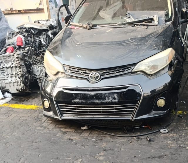 Black Toyota Corolla sedan halfcut front end — bumper, grille, headlights and fog lights, Sharjah market