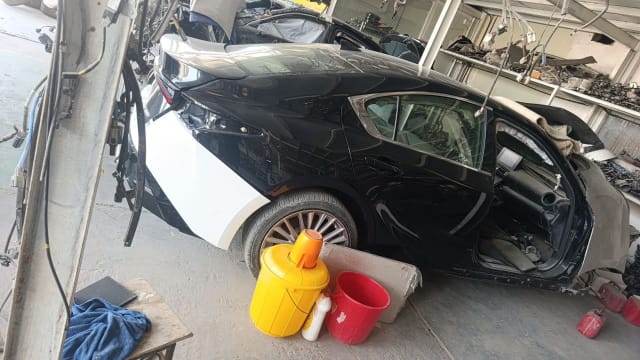 Black Nissan Altima halfcut side view — doors, quarter panel, roof, glass and alloy wheel, Sharjah market