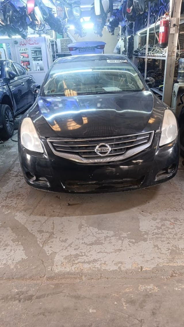 Black Nissan Altima sedan halfcut front — bumper, grille and headlights, Sharjah market