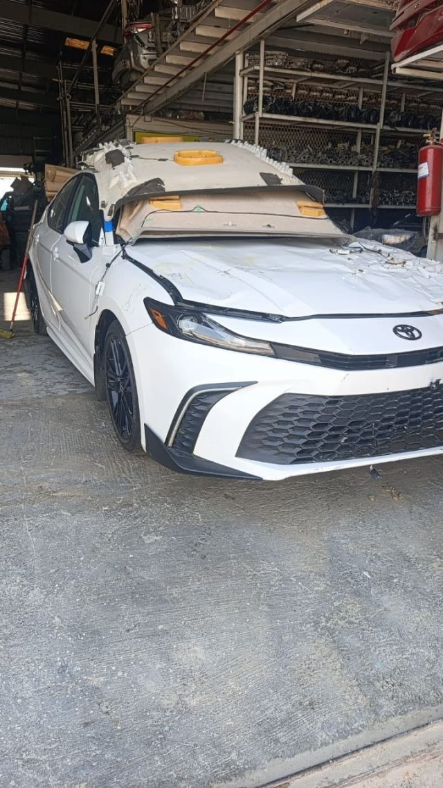 White Toyota Camry sedan front cut for parts — bumper, grille and headlights, Sharjah market