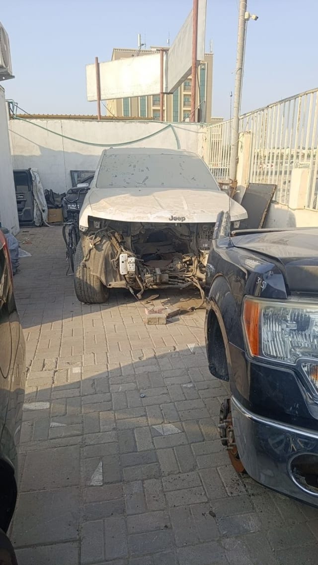 White Jeep front halfcut — raised hood, exposed engine bay and subframe, Sharjah market