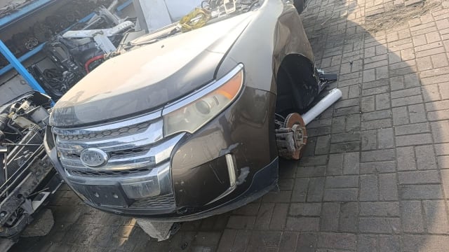 Brown Ford Edge SUV front halfcut — bumper, grille, headlight and fender, Sharjah market
